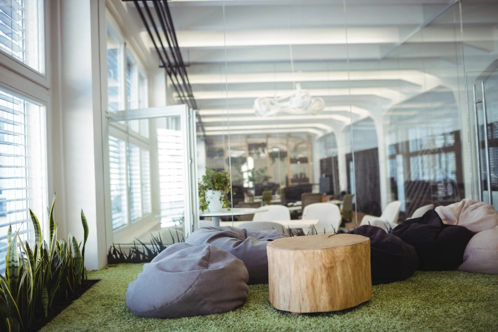 Modern office lounge area with plants and comfortable seating